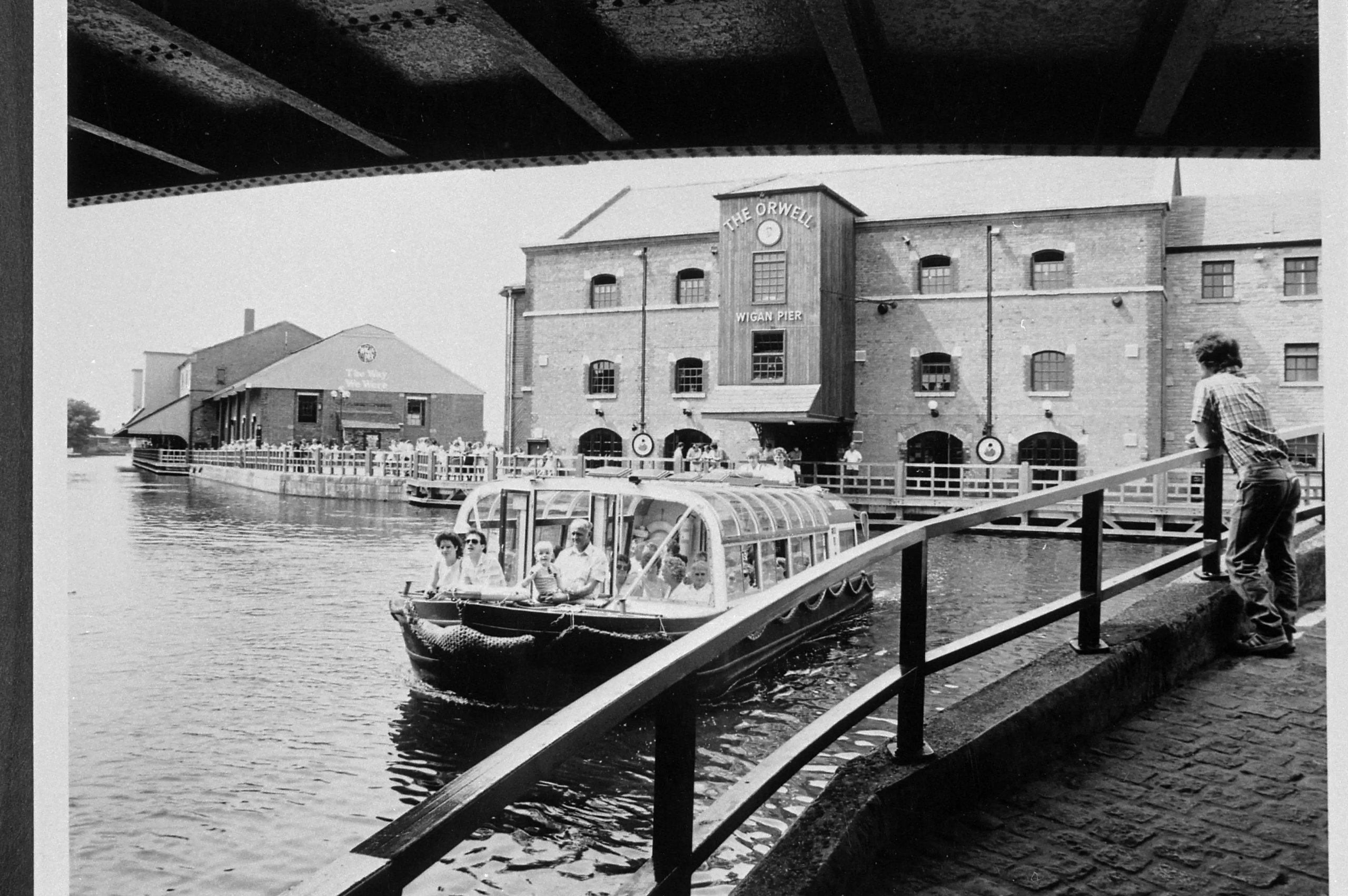 The Orwell building at Wigan Pier, with a boat full of tourists.