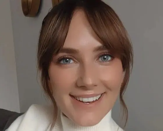 Portrait of a woman with blue eyes and brown hair.