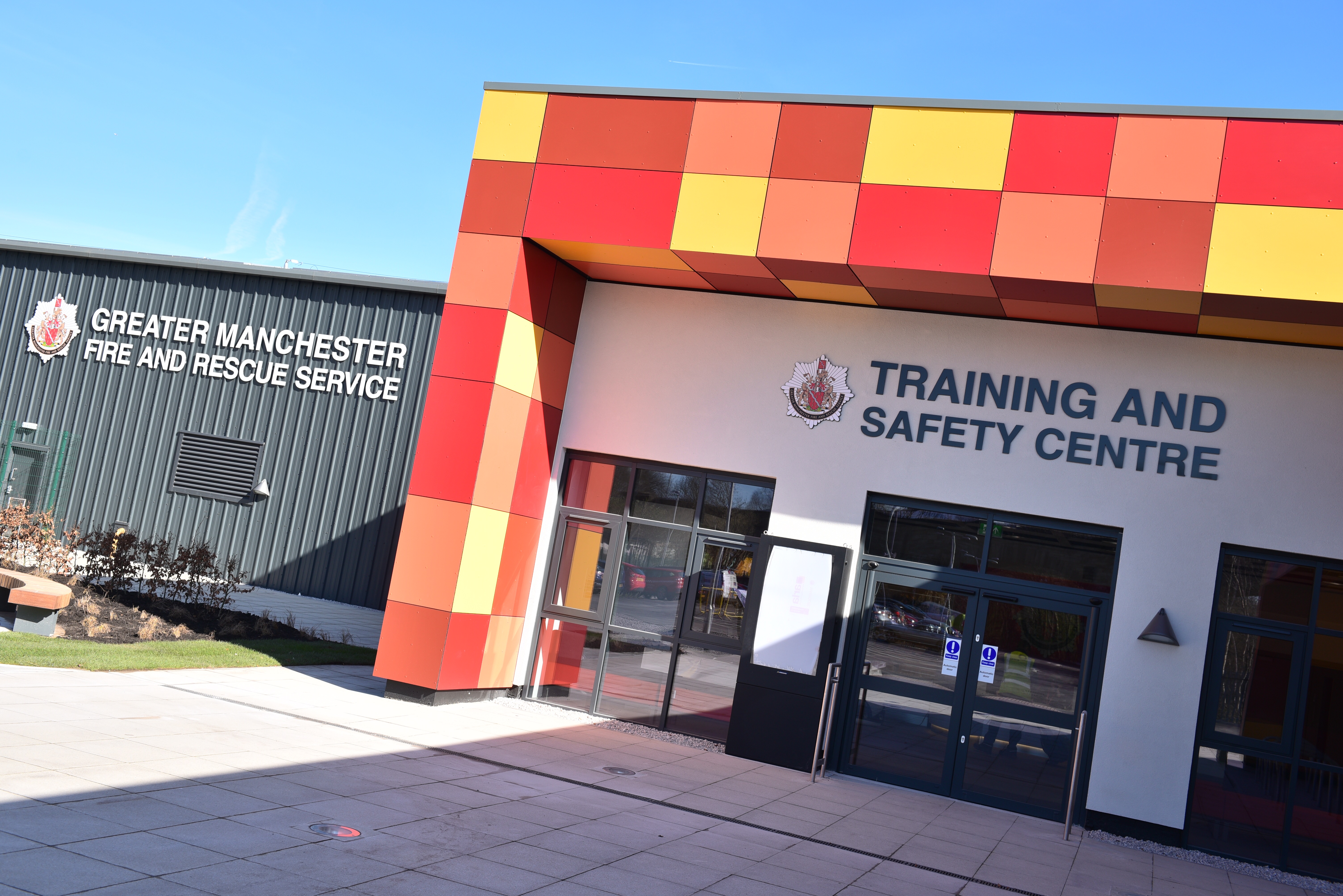 Building with "Training and Safety Centre" sign. Fire station logo and modern architecture.