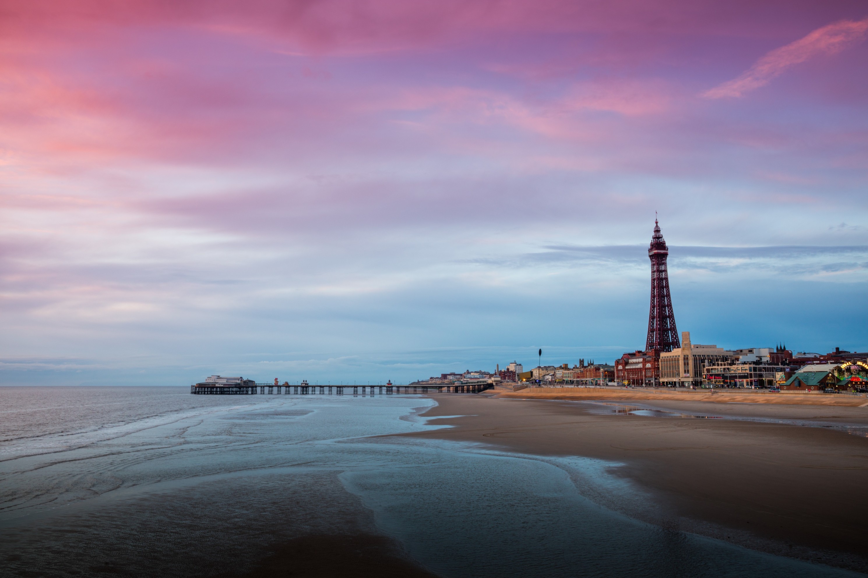 Beach, pier, and Blackpool Tower at sunset.