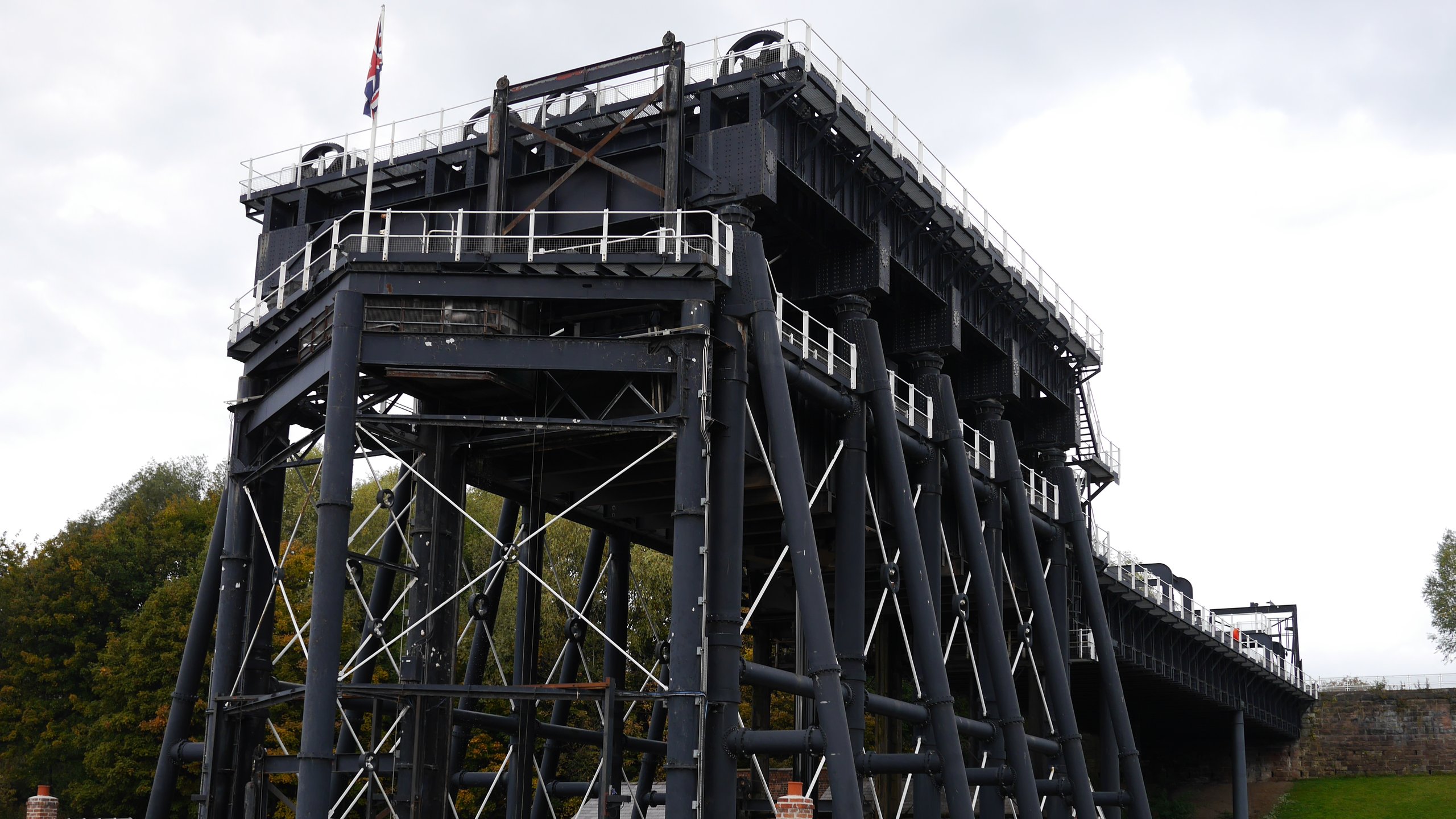 Large black structure with a flag, supporting bridge.