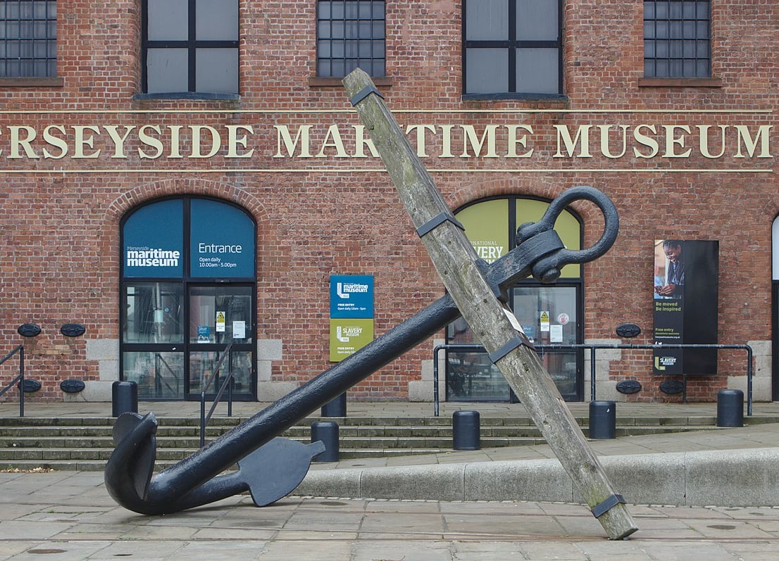 Large anchor in front of the Merseyside Maritime Museum building.