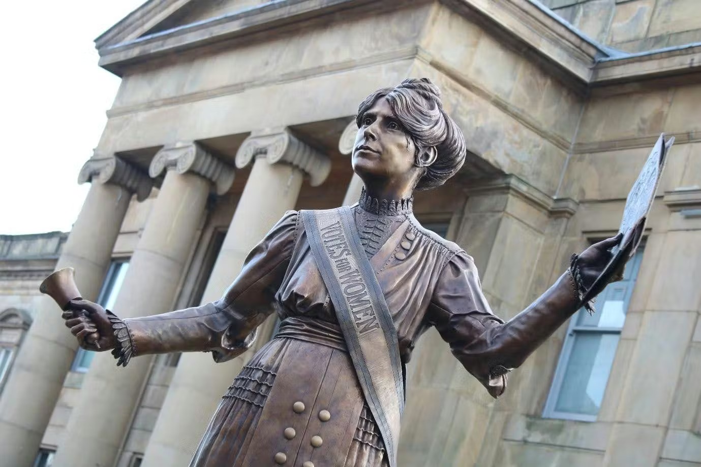 Bronze statue of woman, "Votes For Women" sash.