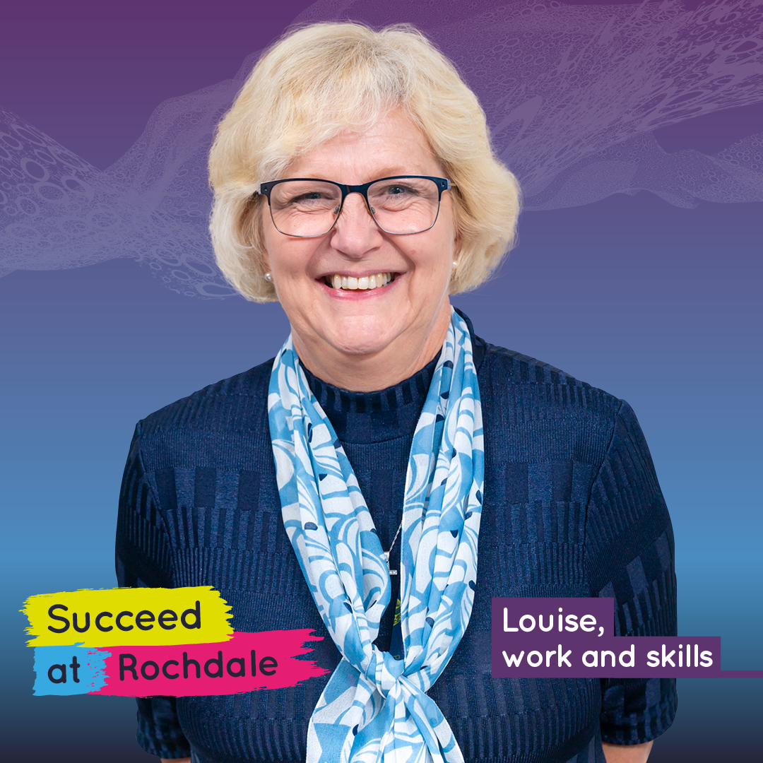 Woman wearing glasses and scarf, smiling.